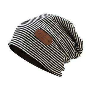 Classic black and white striped knit slouchy beanie with leather patch and metal rivets