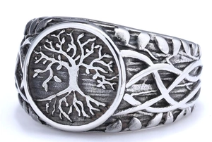 Macro view of vintage stainless steel Tree of Life ring with Celtic knot side patterns