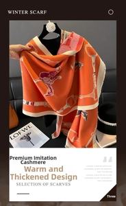 Detail of orange equestrian scarf showing thick cashmere-like texture and tassel fringe