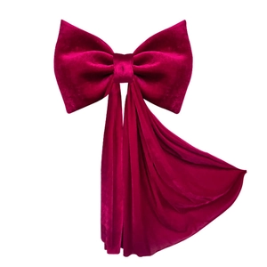 Large red velvet bow decoration for wedding ambiance and festive party backdrops