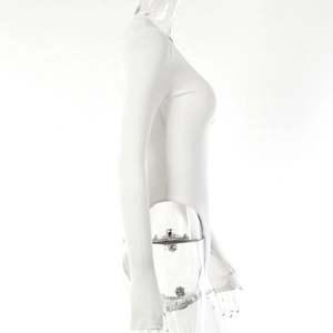 Detail view of white ribbed knit long sleeve bodysuit showing fabric texture and fit
