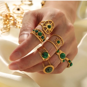 Close-up of bohemian 18k gold plated stainless steel rings with green malachite stones