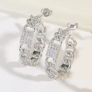 Detail shot of silver C-shaped hoop earrings with pave set sparkling cubic zirconia stones
