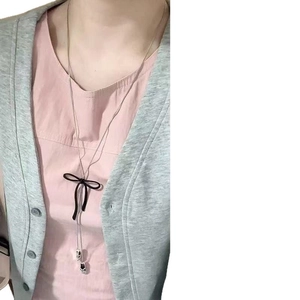 Fashionable long wax cord necklace with hollow flower pendant on female model