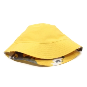 Detail of yellow cotton bucket hat featuring a unique black and white abstract inner print