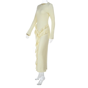 Detail of light yellow ribbed knit dress showing layered ruffles on waist and side seam