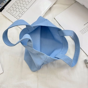 Top view of spacious light blue canvas tote bag interior showing minimalist large capacity