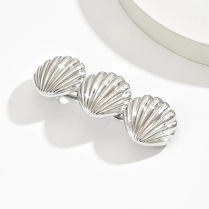Elegant silver metallic hair clip with three shell shapes on a clean white background