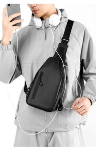 Close-up of waterproof black crossbody chest bag worn by a model in a sporty style