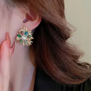 French vintage flower stud earrings with colorful crystals and round pearls on a female model