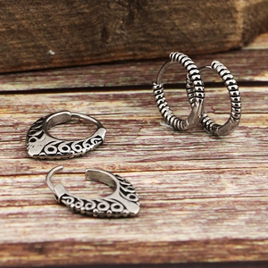 Retro titanium steel earrings with embossed totem pattern and twisted circle design