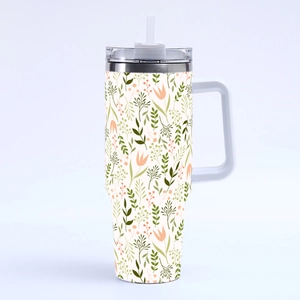 Detail of 40oz insulated tumbler with floral leaf pattern and sturdy white handle