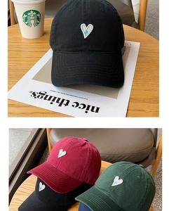 Detail of heart embroidered cotton baseball caps in black, burgundy and dark green colors