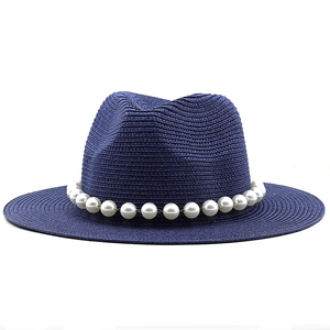Dark blue straw sun hat featuring a wide flat brim and decorative white pearl chain