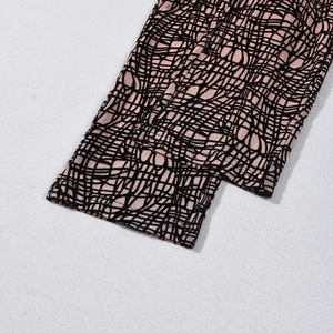 Detailed close-up of pink mesh fabric with black abstract lines and double-layer structure