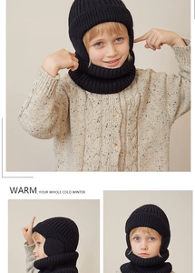 Detail of children's thick ribbed knit winter hat and neck warmer set in black color