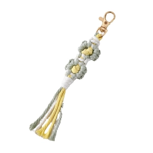 Handmade woven daisy flower keychain with green cotton rope and golden clasp