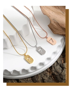 Detailed view of Lucky Number 7 snake bone pendants in gold, silver, and rose gold finish