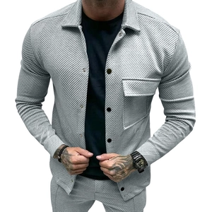 Close-up of light grey twill fabric texture and button detail on men's casual jacket