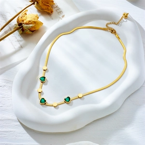 Gold-plated snake chain necklace featuring green heart gems and hexagonal geometric charms