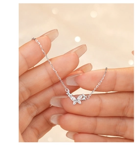 Close-up of sparkling S925 silver butterfly pendant necklace with micro-pave zircons