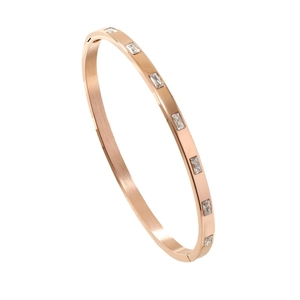 Rose gold stainless steel bangle featuring rectangular diamonds and a brushed metal finish