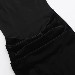 Detail of elegant black velvet dress showing sophisticated layered pleats and stitching