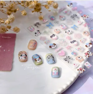 Detail of cute puppy dog nail stickers with floral patterns on pastel manicured nails
