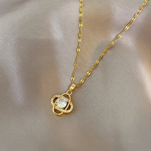 Luxurious gold clover necklace with sparkling pave diamonds and a central zircon stone