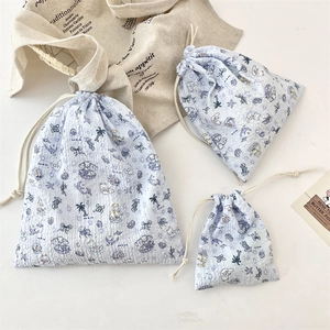 Three sizes of light blue drawstring storage bags with cartoon ocean bear patterns