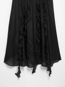 Detail view of black sleeveless V-neck dress with ruffle trim and irregular hemline