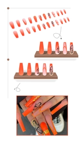 Macro detail of long coffin press-on nails with orange gradient and black butterfly art
