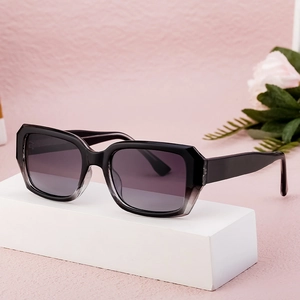 Classic black square sunglasses with gradient lenses displayed on a minimalist white stand