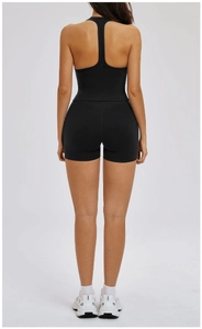 Rear view of black racerback yoga tank top and high waist sports shorts on a model