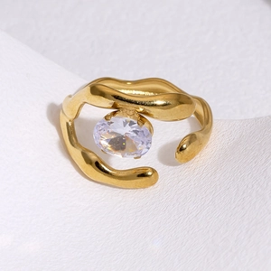 Detail shot of a liquid gold lava ring with a sparkling oval transparent stone