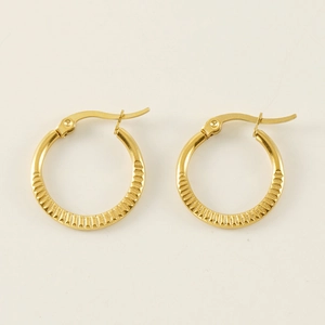 Detail of 18K gold-plated titanium steel hoop earrings with radial grooved texture