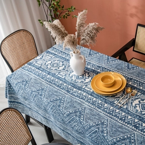 Linen tablecloth with blue geometric tribal pattern in a modern rustic dining setting