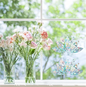 Detailed lotus window sticker creating rainbow prism effects in a bright room