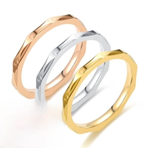 Macro detail of 2.5mm titanium steel rings in gold, silver, and rose gold finish