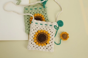 Detail showing hand-woven texture and 3D sunflower pattern on these small crochet bags