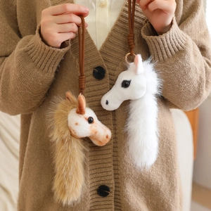 Plush cartoon horse head bag charm in white and spotted brown with soft faux fur