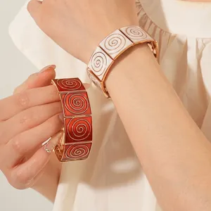 Vintage vintage enamel wide bangle with gold spiral pattern in red and white colors