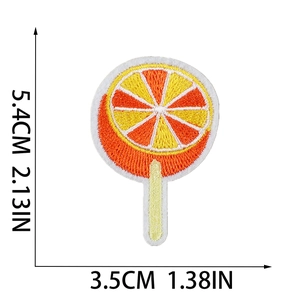 Lollipop shape orange fruit embroidery patch with dimensions 5.4cm by 3.5cm on white base