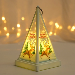 Detail of Christmas LED lantern featuring reindeer and snowflakes with warm bokeh lights