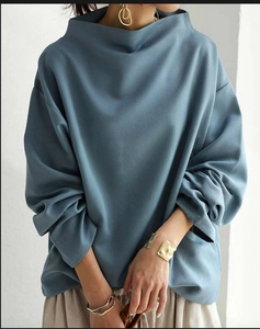 Women's loose light blue long-sleeved turtleneck top with a soft knitted texture