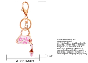 Detail of crystal rhinestone orchid keychain with pink high heel and handbag charms
