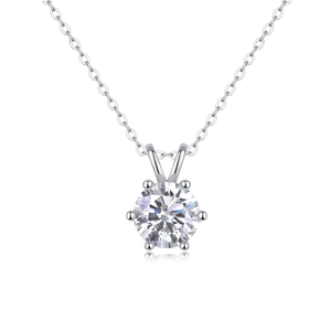 Detailed close-up of a six-prong silver necklace with a brilliant round-cut moissanite