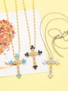 Detailed shot of cross necklaces with colorful drop stones on a yellow background
