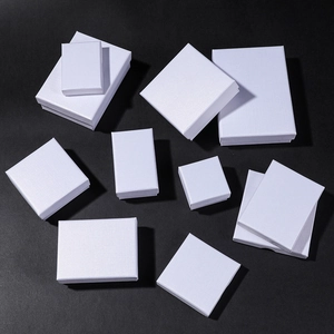 White linen textured jewelry gift boxes in various sizes on a black background