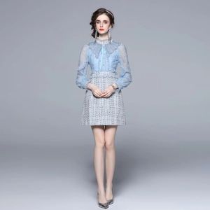 Blue lace top and tweed mini dress set with pearl buttons on model